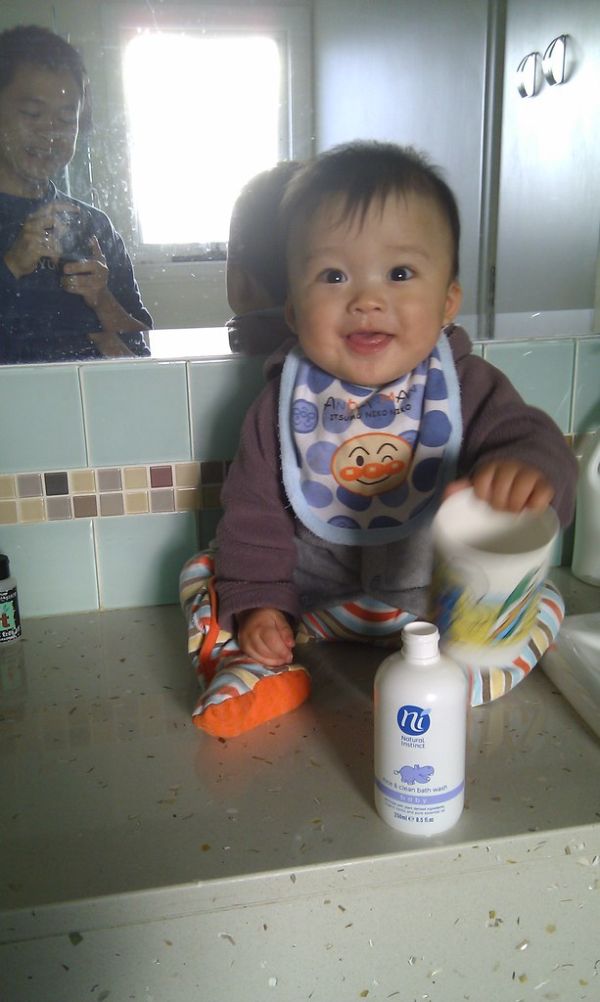Isaac sitting on the bathroom benchtop