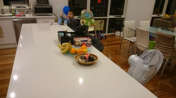 Cleared kitchen bench top, apart for some fruit and Isaac's toys